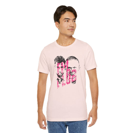 A man wearing a light pink crewneck t-shirt with a graphic print of two faces and the word 'ROPE' in pink and black, paired with blue jeans, against a plain white background.