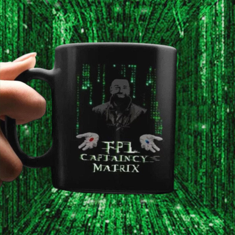 Black mug with a design of a man and text against a green matrix background