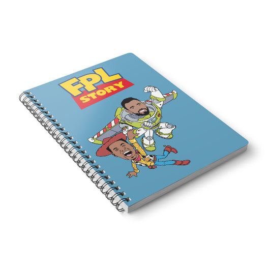 Notebook with cartoon design featuring two characters and 'FPL Story' text on a blue background