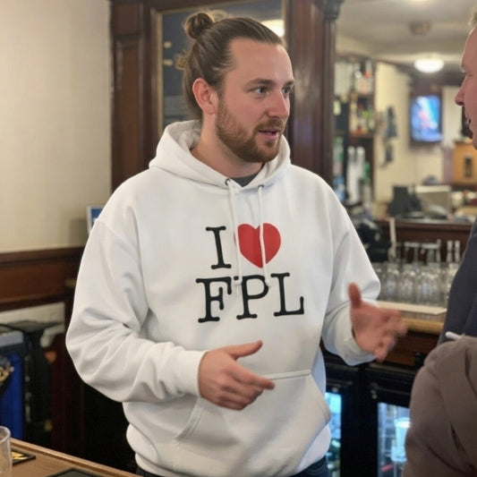 Man wearing a white hoodie with 'I ❤️ FPL' text in a bar setting