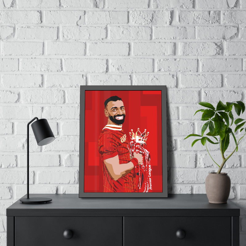 Framed artwork of a person in a red jersey on a white brick wall with a black cabinet and lamp.