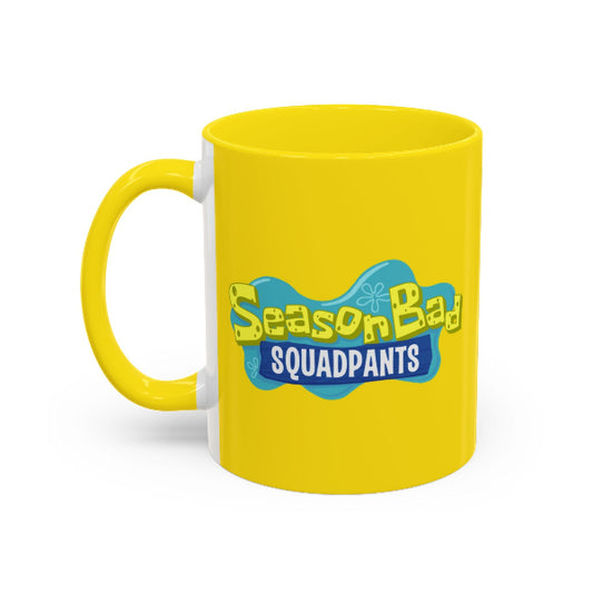 Yellow mug with 'SeasonBad Squadpants' text on a white background