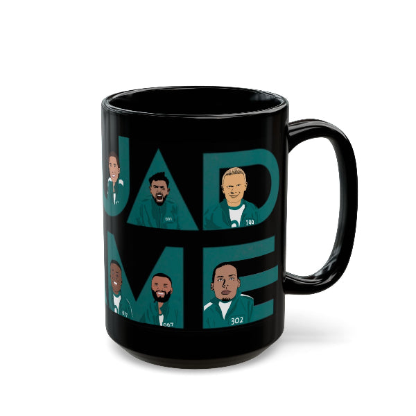 Black mug with graphic design of faces and text on a white background
