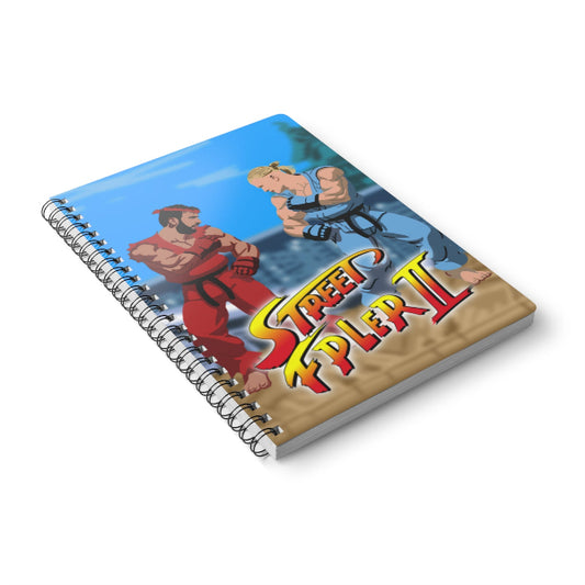 Notebook with 'Street Fighter II' cover featuring two characters on a white background