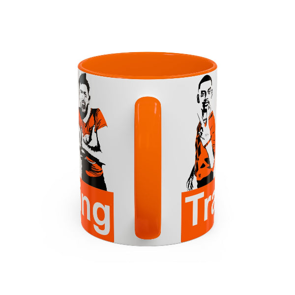 Mug with orange interior and handle, featuring a graphic design on a white background