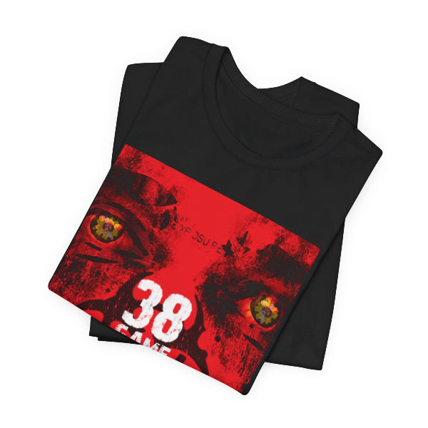 A folded black t-shirt with a large red graphic print on the front, featuring a stylized cat face, the number 38, and the text '38 CAGE' and 'IF JESUS IS LORD'.