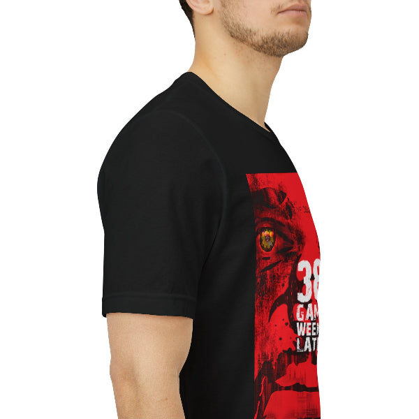 A man wearing a black short-sleeve t-shirt with a red graphic print on the front featuring a stylized face and white text, shown from a side profile against a white background.