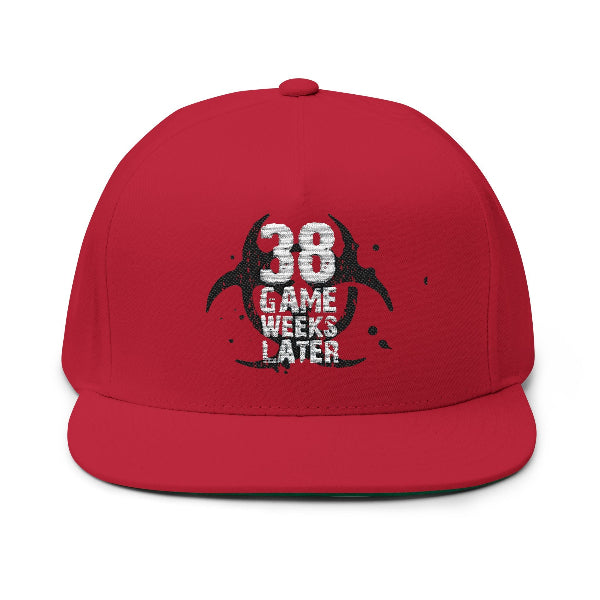 A red flat-brim baseball cap with a distressed black and white graphic on the front that reads '38 GAME WEEKS LATER' over a circular logo, shown on a plain white background.