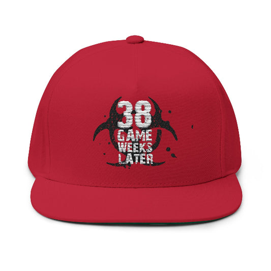 A red flat-brim baseball cap with a distressed black and white graphic on the front that reads '38 GAME WEEKS LATER' over a circular logo, shown on a plain white background.