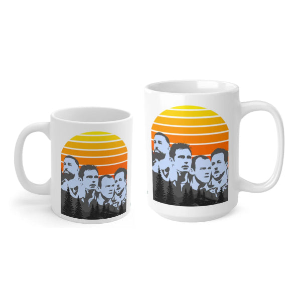 Two white mugs with a design of a group of people against a sunset background.