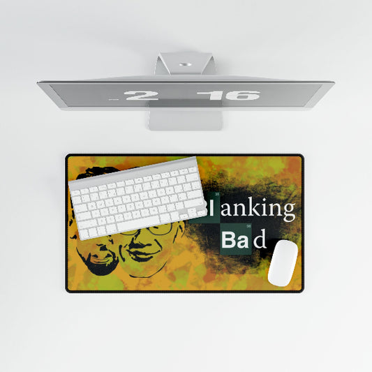 Desk setup with a colorful mouse pad, keyboard, and monitor on a white background