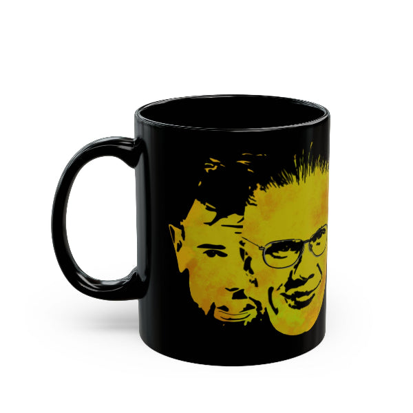 Black mug with yellow graphic of a face on a white background