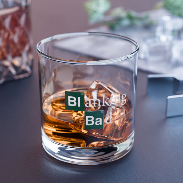 Glass of whiskey with 'Blanking Bad' text on a dark surface