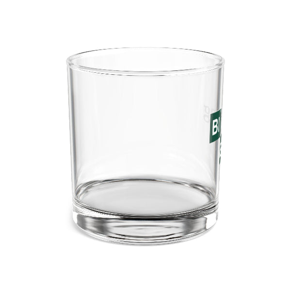 Clear glass tumbler with a green logo on a white background