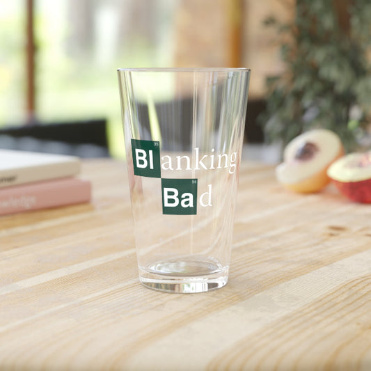 Clear glass with 'Blanking Bad' text on a wooden surface
