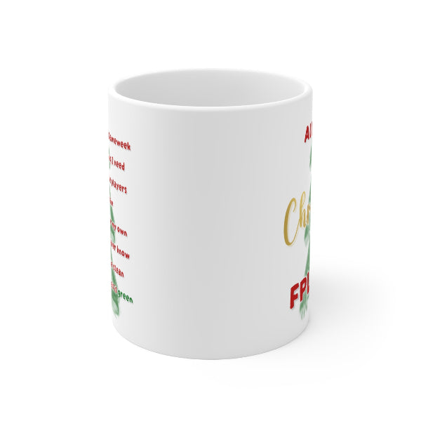 A white ceramic mug with Christmas-themed text and holly graphics, shown on a clean white background.