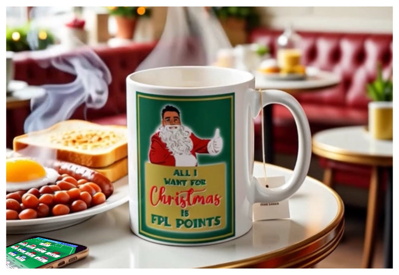 Mug with Santa Claus graphic and text on a table with breakfast items and a smartphone.