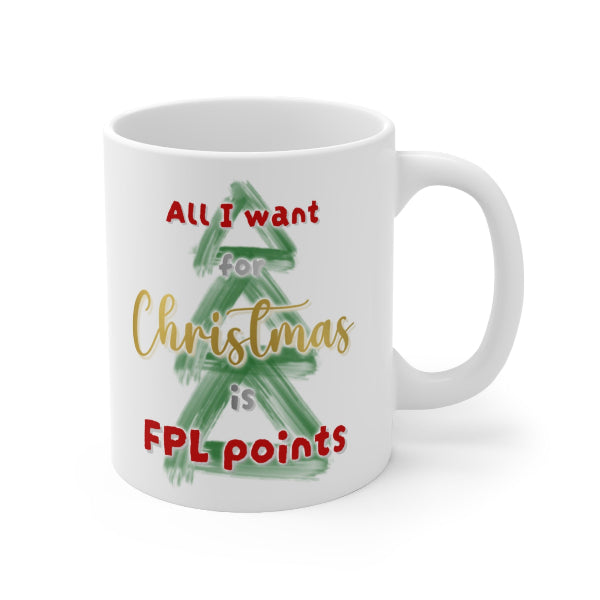 A white ceramic mug with a holiday-themed graphic that reads 'All I want for Christmas is FPL points' in red and gold lettering over a green painted Christmas tree.