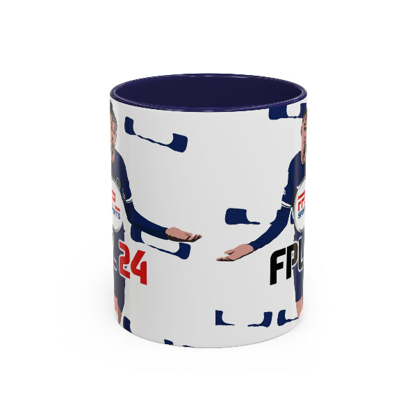 A white ceramic mug with a dark navy blue interior and rim, featuring a printed graphic of a female cyclist in a navy jersey with red and white accents, on a plain white background.