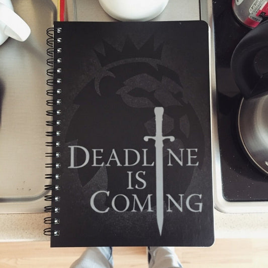 Notebook with 'Deadline is Coming' design on a kitchen counter