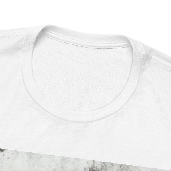 Close-up of a plain white crew-neck t-shirt showing the inner collar and ribbed neckline, photographed against a white background with a small gray textured surface visible at the bottom edge.