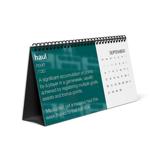 A spiral-bound desk calendar standing on its own, shown at an angle on a white background. The left page has a teal background with the word 'haul' and a dictionary-style definition.