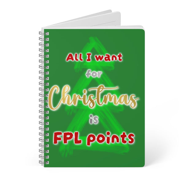 A spiral-bound notebook with a green cover featuring a stylized Christmas tree graphic and the text 'All I want for Christmas is FPL points' in red, gold, and white lettering, shown on a white background.
