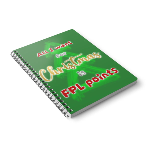 A spiral-bound notebook with a green cover featuring a Christmas tree graphic and the text 'All I want for Christmas is FPL points' in red, yellow, and white lettering, shown on a white background.