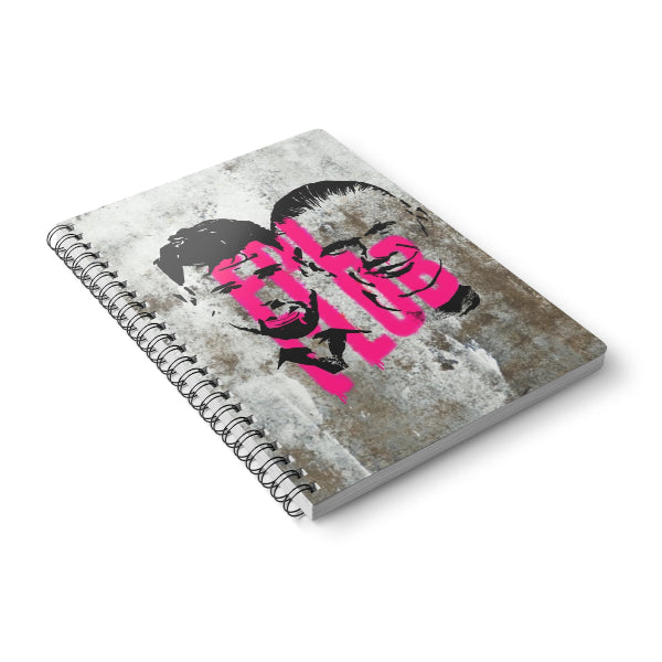 Notebook with a graphic design on the cover featuring a face and text, on a white background
