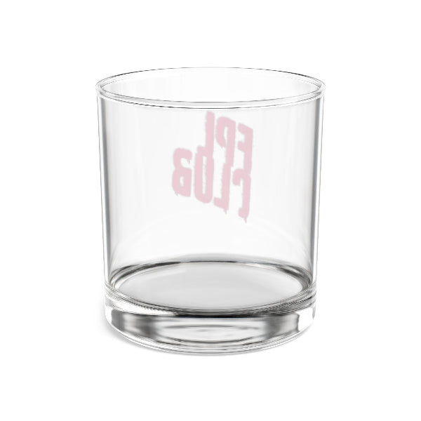 Clear glass tumbler with pink text on a white background