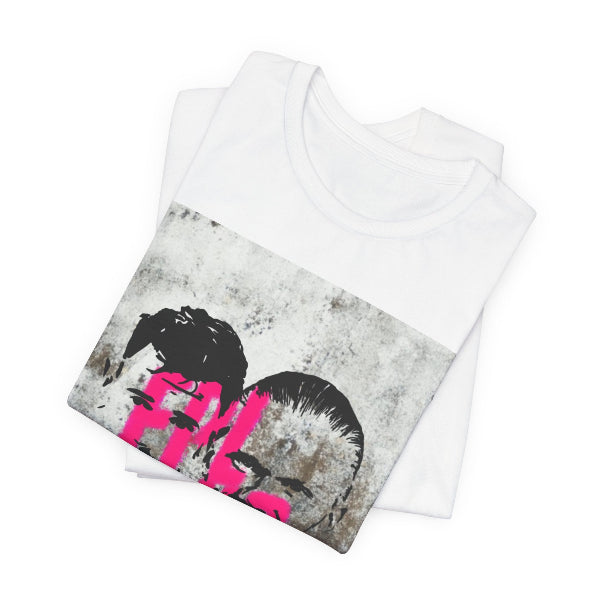 A folded white crewneck t-shirt featuring a distressed graphic print on the front with black hair silhouettes and bright pink text, displayed on a clean white background.