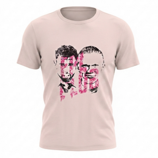 A light pink crewneck t-shirt featuring a stylized graphic print of two men's faces in black and pink on the front, displayed on a clean white background.