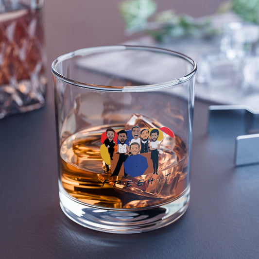 Glass tumbler with a colorful design of people and text on a reflective surface.