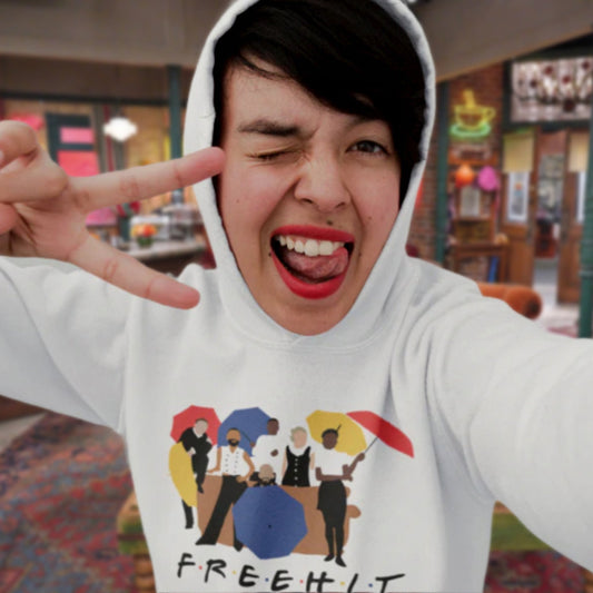 Person wearing a hoodie with a graphic design and text, making a peace sign.