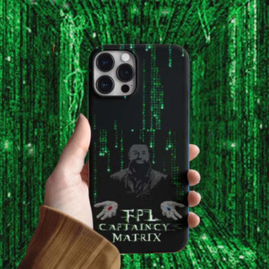 Phone case with a design of a character and text, held against a green matrix background.
