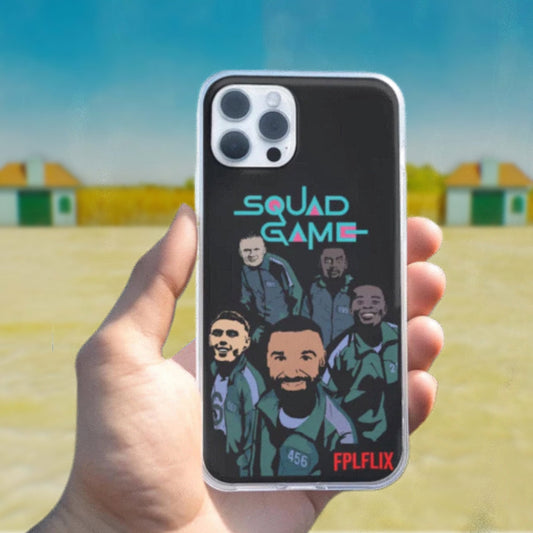 Phone case with 'Squad Game' design held in a hand with a blurred outdoor background