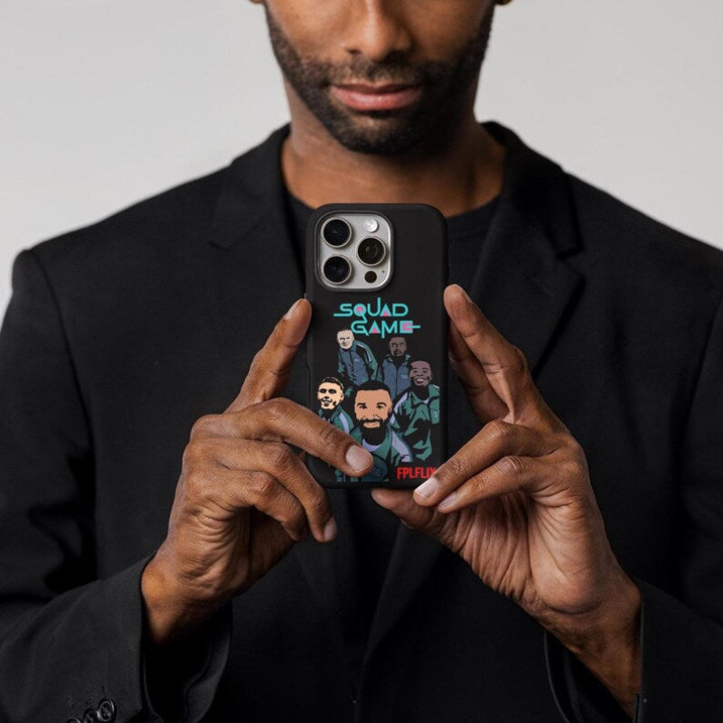 Person holding a phone with a 'Squad Game' phone case featuring illustrations of people.