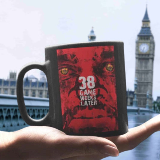 Black mug with red graphic design held in front of the London skyline, featuring Big Ben.