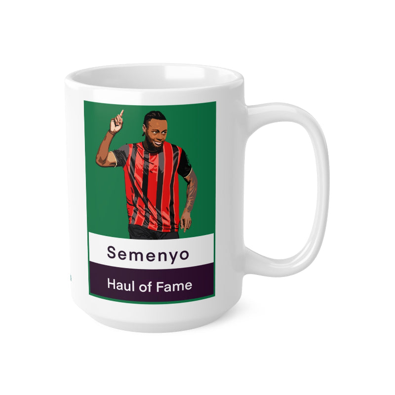 White mug with a graphic of a person in a red and black striped jersey on a green background, with text 'Semenyo Haul of Fame' on a white background.