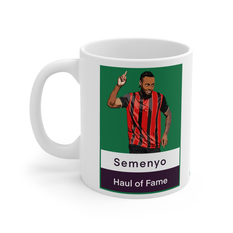 Mug with a graphic of a person in a red and black striped shirt, labeled 'Semenyo Haul of Fame', on a green background.