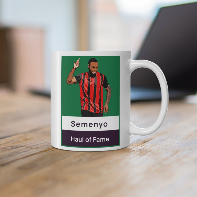 Mug with a graphic of a person in a sports jersey on a desk with a blurred background