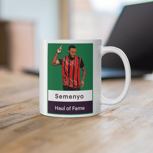Mug with a graphic of a person in a sports jersey on a desk with a blurred background