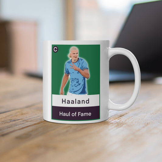 Mug with a graphic of a person in a sports jersey on a wooden surface.