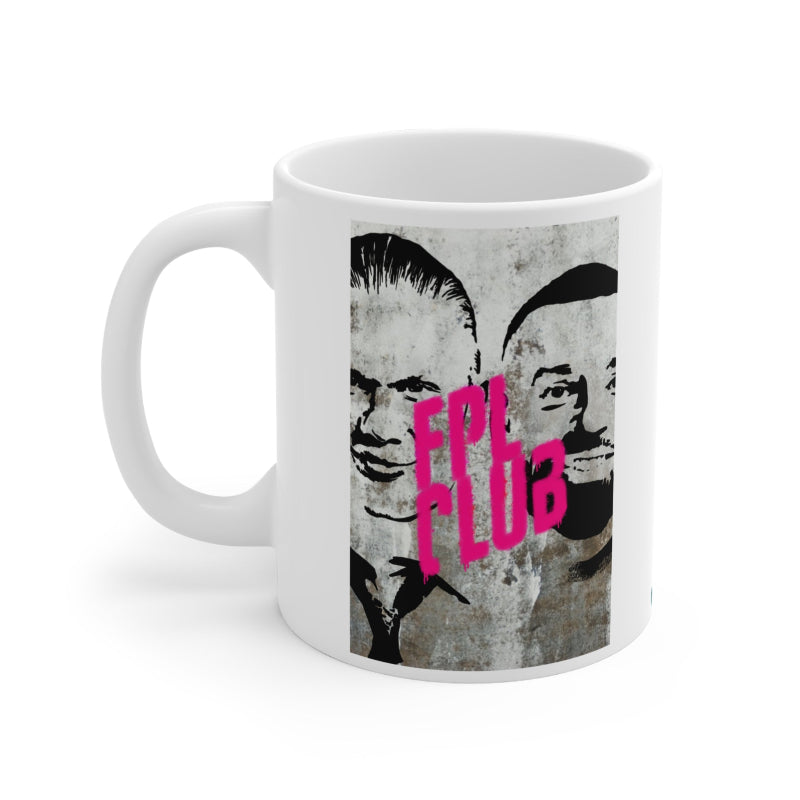 White mug with graphic design featuring two faces and pink text on a white background