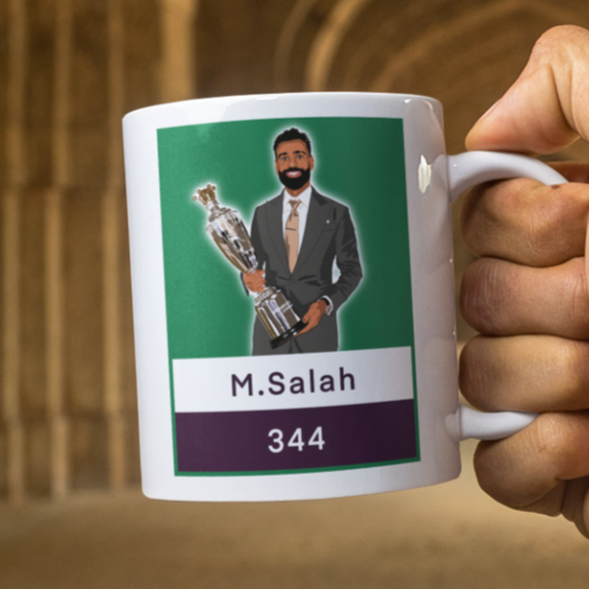Hand holding a mug with a graphic of a person in a suit and text, set against an arched stone wall.