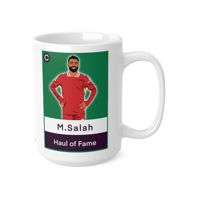 White mug with a graphic of a person in a red sports uniform on a green background, featuring the text 'M.Salah Haul of Fame'.