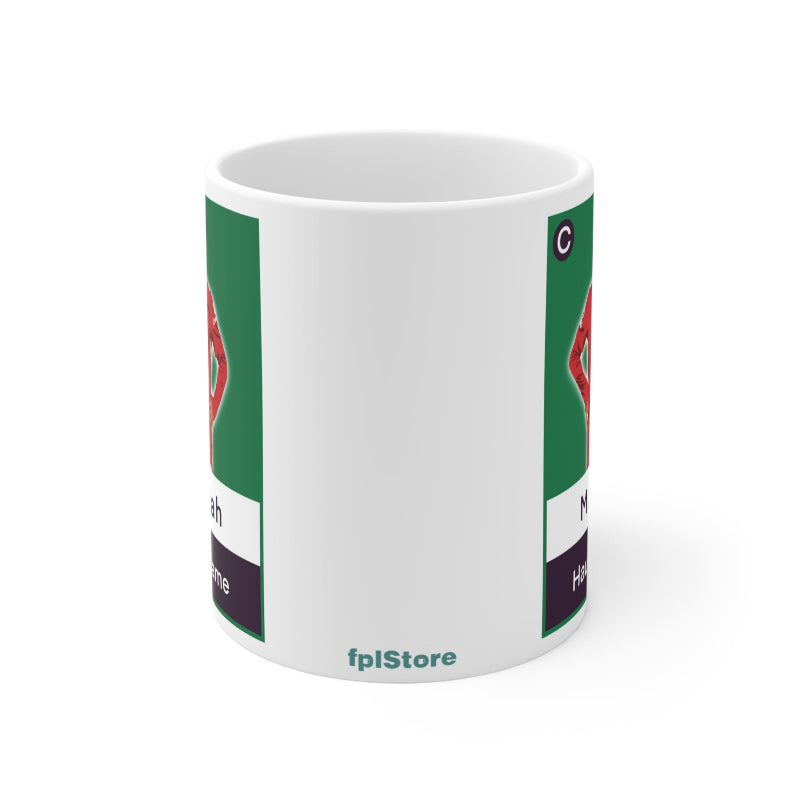 White mug with green and red design on a white background