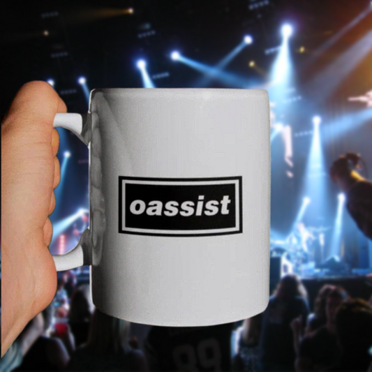 White mug with 'oassist' logo held in front of a concert crowd with bright lights.
