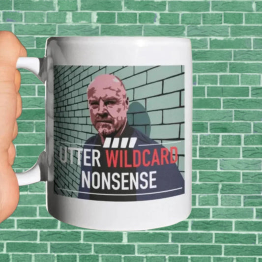 Mug with a graphic design of a person against a brick wall and text on a green tiled background
