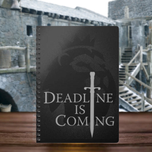 black notebook on table with words Deadline Is Coming